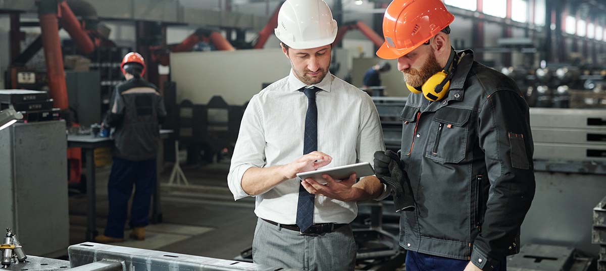 Photo of engineers with tablet, Enhancing Business Performance Through Quality Management Systems